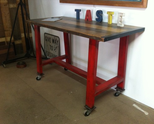 Red Metal Island Bench with Blackbutt Top on Castors